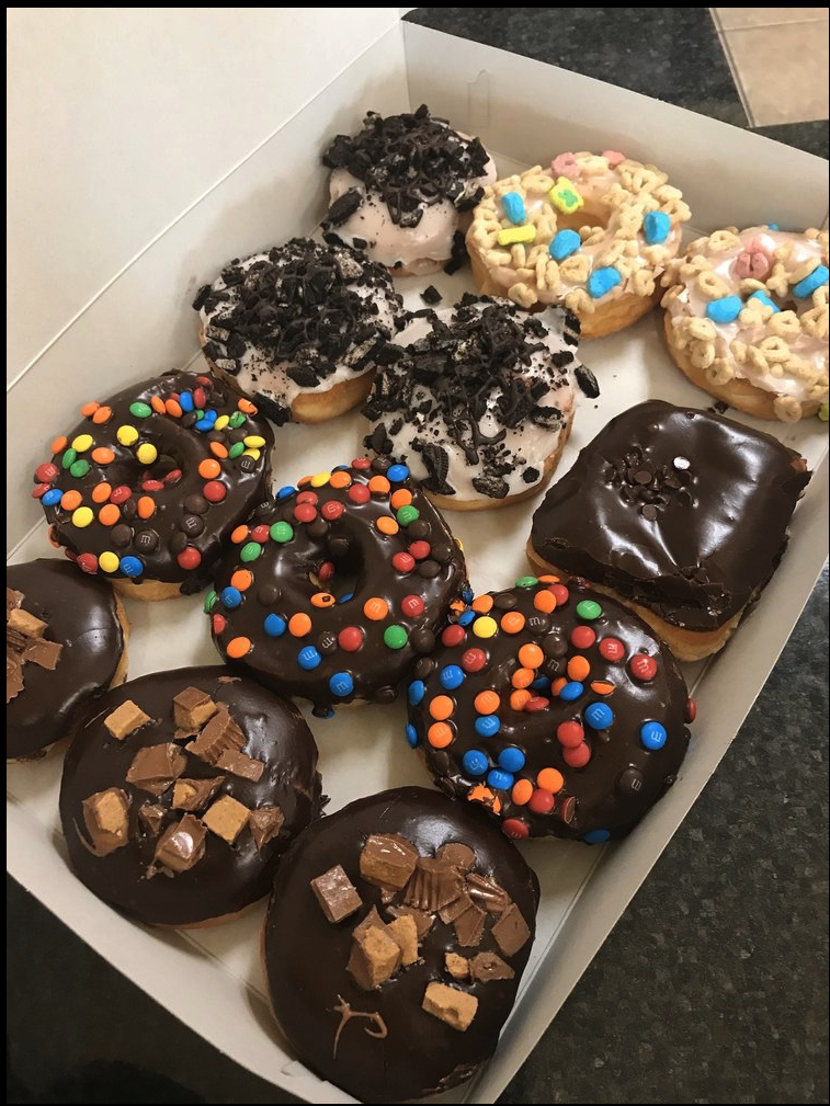 A box of Liv's specialty donuts with M&Ms, Oreo, Lucky Charms, and Reese's